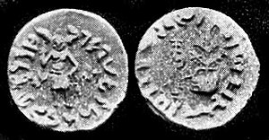 Coin of Dharaghosha, king of the Audumbaras, in the Indo-Greek style, circa 100 BCE.[1] Obv: Standing figure, probably of Vishvamitra, Kharoshthi legend, around: Mahadevasa Dharaghoshasa/Odumbarisa "Great Lord King Dharaghosha/Prince of Audumabara", across: Viçvamitra "Vishvamitra". Rev: Trident battle-axe, tree with railing, Brahmi legend identical in content to the obverse.[1] of
