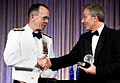 US Navy Admiral Mike Mullen (in optional white semi-formal mess dress uniform) congratulates former British Prime Minister Tony Blair at the Atlantic Council of the United States Distinguished Leadership Award Gala (2008).