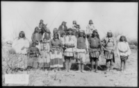 "Scene in Geronimo's camp...before surrender to General Crook, March 27, 1886: group of 18 men, women and children."