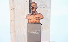 A metal bust of Cornelius Francis Adjetey from the chest up, on a stone pedestal