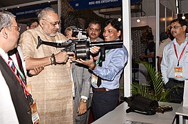 Minister holding a 40 mm Multi Grenade Launcher (MGL) and on the table the 38 mm Multi Shell Launcher both manufactured by OFT