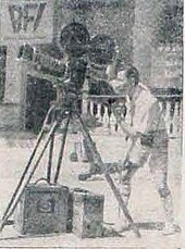 A grainy picture of a man with a video camera