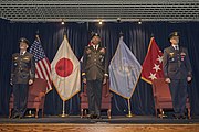 UNC and UNC-R officers pictured during a 2018 UNC-R change of command ceremony. In the background are the flags of the United States, Japan, Australia, United Nations, as well as General Brooks' position standard.