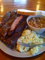 Ribs, potato salad, baked beans, and bread