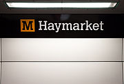 Station signage at Haymarket, branded in the new corporate colour scheme.