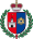 A coat of arms depicting a grey castle on a red background on the left and a blue eye in a yellow triangle on the right