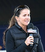 Brandi Chastain holding a microphone with an ESPN logo
