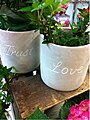 Flowerpots with the words "Trust" and "Love" on them