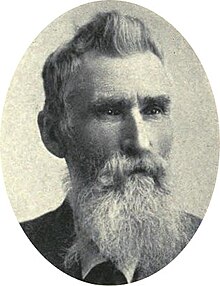 19th-century portrait photograph of a man with a full beard in a suit and tie