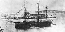 Three-masted warship at anchor in a bay