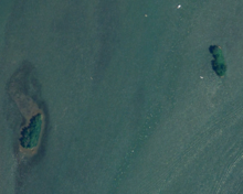 An aerial photograph of two small islands separated by water