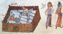 On the left a rectangular sheep pen with eighteen sheep standing or lying very close together, a person milking a sheep and a person holding the head of a sheep, probably in order to shear it; on the right two persons holding vessels on their head