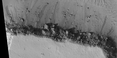Close view of cap rock breaking up into boulders, as seen by HiRISE under HiWish program