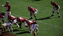 American football players in position prior to a snap.