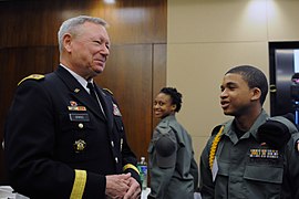 Army Gen. Frank Grass, chief, National Guard Bureau, converses with a Capital Guardian Youth ChalleNGe Academy cadet.