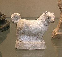 A terracotta figure of a small, fluffy dog, made in Italy in the 1st century BC – 1st AD