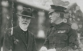 a black and white photograph of two men, one in uniform