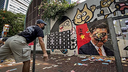Protesters throwing eggs at a portrait of Communist Party general secretary Xi Jinping