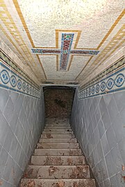 Portalgruft mit vergittertem Portal und verzierter steiler Treppe in die Gruft