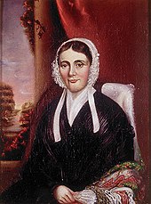 A portrait of Isabel, Mackenzie's wife. Isabel is seated in a chair facing part-way leftwards.