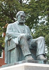 Statue of a bearded, seated man in bronze