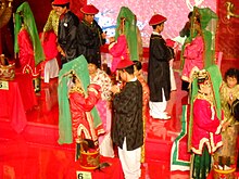 Several couples dressed in red, black and green
