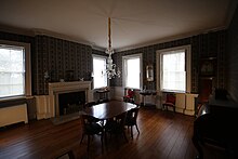 The dining room, which has several chairs arranged around a table