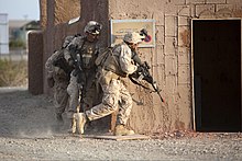 Marines prepare to breach a building during a mock helicopter raid at YTC, part of U.S. Marine Corps Weapons and Tactics Instructor Course.