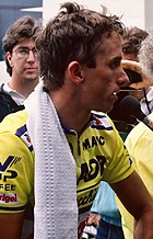 LeMond's head shown from the side, wearing a cycling jersey with a towel wrapped around his shoulders