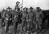 Karl Linderfelt, center. Photo caption reads: "Officers of the Colorado National Guard. From left to right: Captain R. J. Linderfelt, Lieut. T. C. Linderfelt, Lieut. K. E. Linderfelt, (who faced the charge of assault upon Louis Tikas, the dead strike leader), Lieut. G.S. Lawrence and Major Patrick Hamrock. The last three were in the Ludlow battle of April 20, 1914."