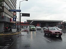 Image of a street sign and a metro station found at the street level