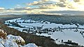 A view of the village of Cussey in the snow from a nearby hill