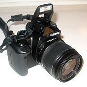 The Canon EOS 400D with kit lens EF-S 18-55mm and neck strap