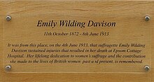Plaque dedicated to Davison. In addition to her name and dates, the text reads "It was from this place, on the 4th June 1913, that suffragette Emily Wilding Davison sustained injuries that resulted in her death at Epsom Cottage Hospital. Her lifelong dedication to women's suffrage and the contribution she made to the lives of British women past and present, is remembered.