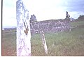 Headstone on the grave of St Cummin, with the old church of St Cummin (dated to pre-8th Century)