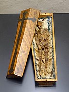 Memento mori in the form of a small coffin, 1700s, wax figure on silk in a wooden coffin (Museum Schnütgen, Cologne, Germany)