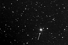 photograph of stars with an arrow pointing to one of them