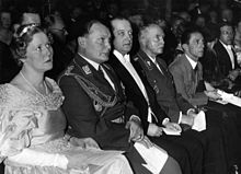 A group of seated people in formal dress.
