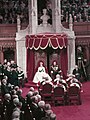 The Queen, wearing her coronation gown, and Prince Philip seated at their thrones, during the opening of the 23rd Canadian Parliament, 14 October 1957