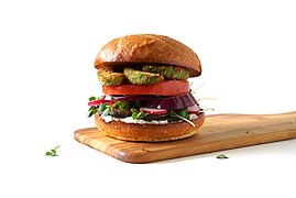 A veggie burger with deep-fried avocado (below the top bun)