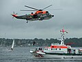 SK Berlin, a 27m-class cruiser of the DGzRS, and a SeaKing helicopter of the German Navy