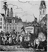A population celebrates while soldiers escort secured wagon of material through the city. A pair of twin spires tower above the city, indicating the city is Zurich, Switzerland.