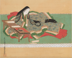 Japanese woman in multi-layered clothing writing at a desk