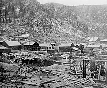 Lumber under snow in Montgomery, Colorado, 1880s