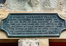 Bronze plaque in memory of Selkirk affixed to a building
