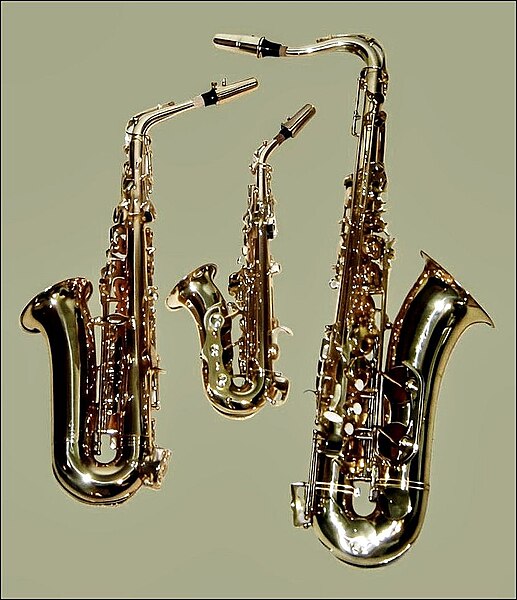 Saxophones – from left to right, an E♭ alto saxophone, a curved B♭ soprano saxophone, and a B♭ tenor saxophone