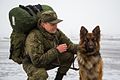 Russian sapper with his German Shepherd mine detection dog in Syria