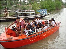 NDRF shifting school children to safer places during Cyclone Aila, 2009