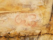 A pictograph of a human figure floating over a cross-in-circle.[38]