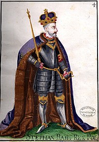 A bearded middle-aged man wearing a crown and armour
